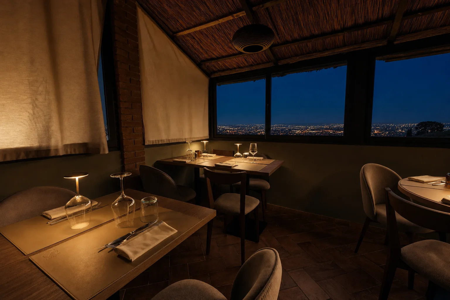 La sala di Flavore la sera, con la pianura illuminata oltre le finestre